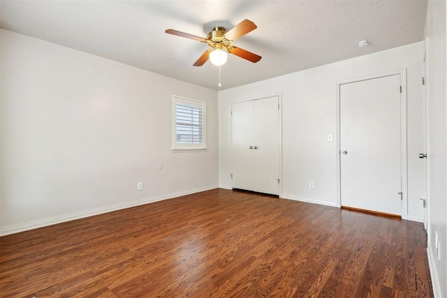 unfurnished bedroom featuring baseboards, a ceiling fan, and wood finished floors