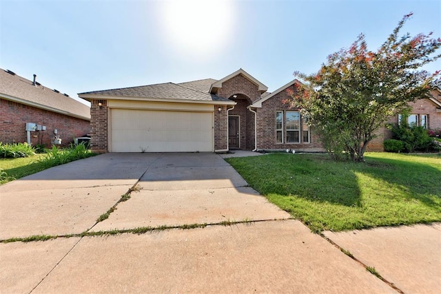 view of front of home featuring brick siding, a garage, concrete driveway, and a front lawn