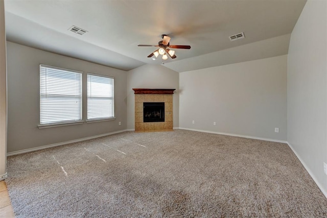 unfurnished living room with ceiling fan, carpet flooring, baseboards, and vaulted ceiling