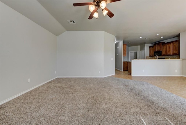 unfurnished living room with light carpet, ceiling fan, baseboards, recessed lighting, and lofted ceiling