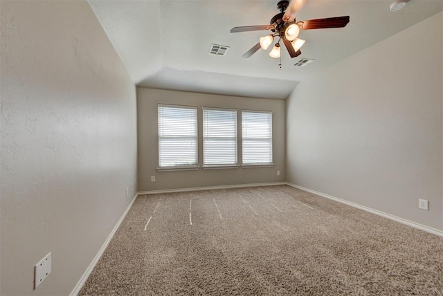 spare room featuring light carpet, a ceiling fan, lofted ceiling, baseboards, and a smoke detector