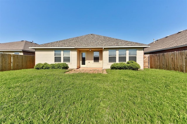 back of property with a patio area and roof with shingles
