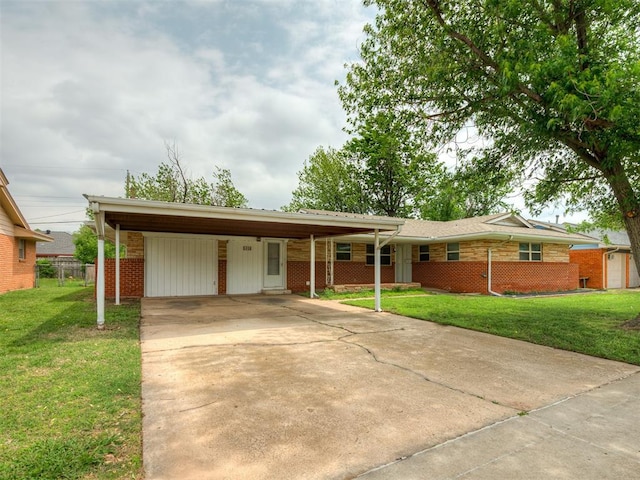 ranch-style house with fence, a front lawn, brick siding, an attached carport, and concrete driveway