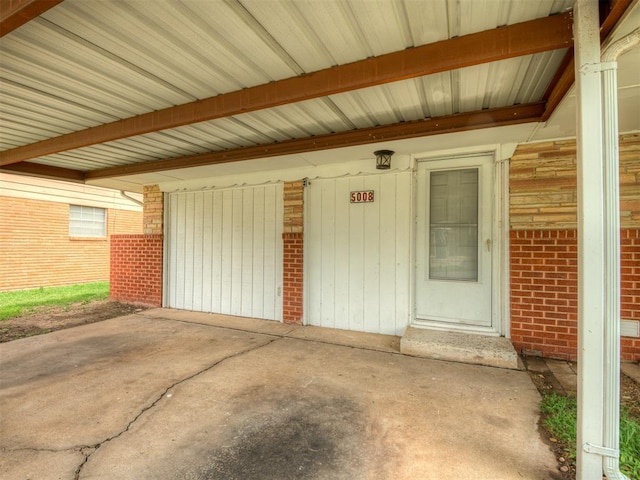 doorway to property with brick siding