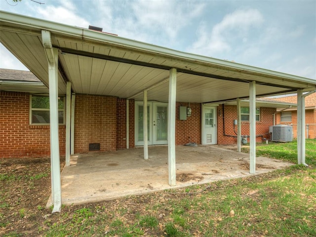 exterior space featuring central AC and an attached carport