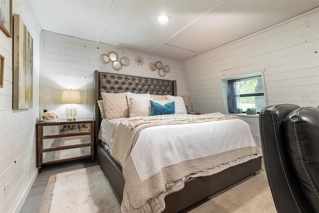 bedroom featuring wood walls