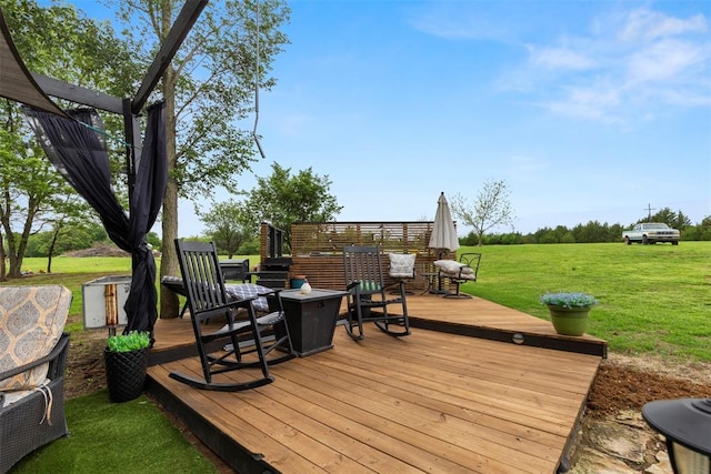 wooden terrace featuring a yard