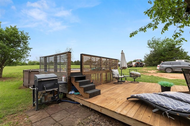 wooden deck featuring a yard and area for grilling