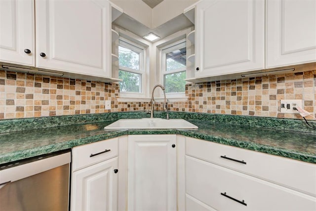 kitchen featuring a sink, dark countertops, white cabinets, and stainless steel dishwasher