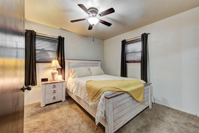 carpeted bedroom featuring baseboards and ceiling fan