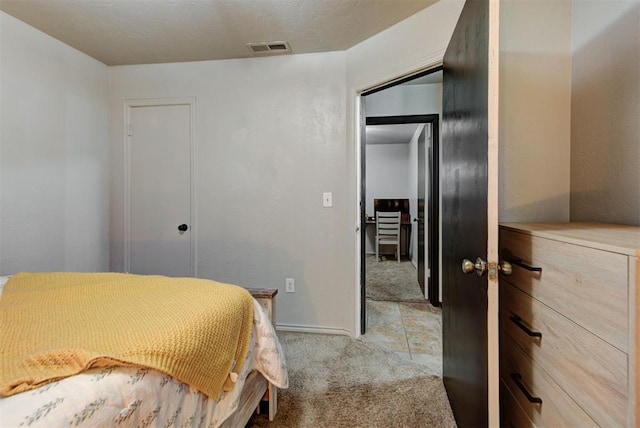 bedroom with carpet floors, baseboards, and visible vents