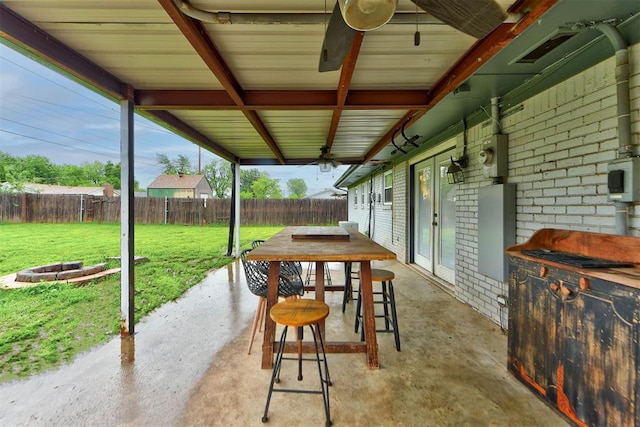 view of patio featuring a fenced backyard and an outdoor fire pit