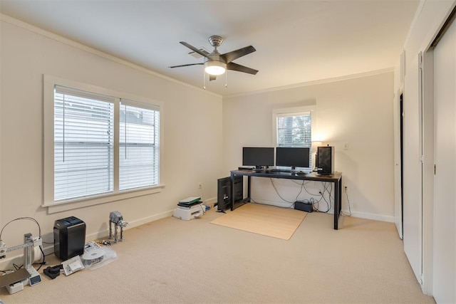 carpeted home office with crown molding, a ceiling fan, and baseboards