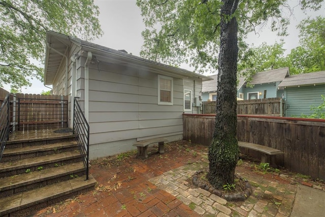 rear view of property with a patio and a fenced backyard