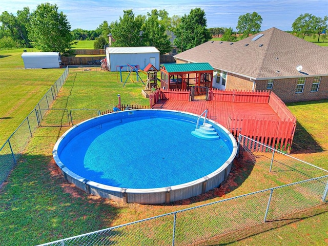 910860 S 3350th Rd, Wellston, OK 74881 - view of swimming pool featuring a fenced backyard, a deck, a yard, and an outdoor structure