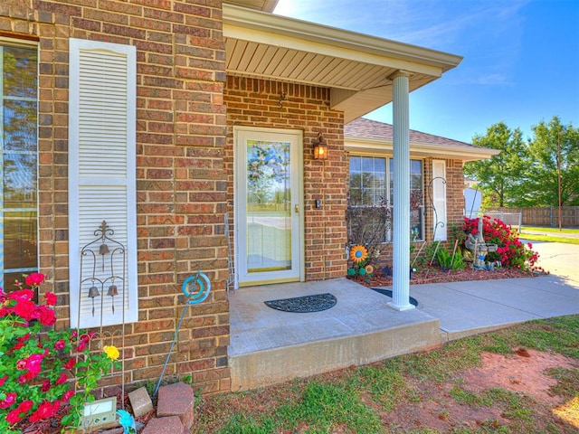 910860 S 3350th Rd, Wellston, OK 74881 - doorway to property featuring roof with shingles, fence, and brick siding