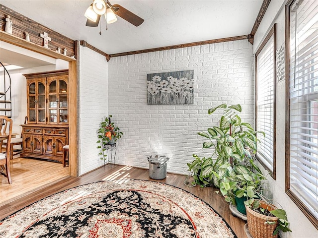 910860 S 3350th Rd, Wellston, OK 74881 - interior space with ornamental molding, a healthy amount of sunlight, brick wall, and wood finished floors