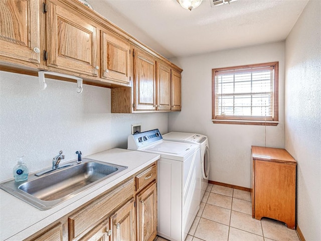 910860 S 3350th Rd, Wellston, OK 74881 - clothes washing area featuring a sink, cabinet space, light tile patterned flooring, visible vents, and washing machine and clothes dryer