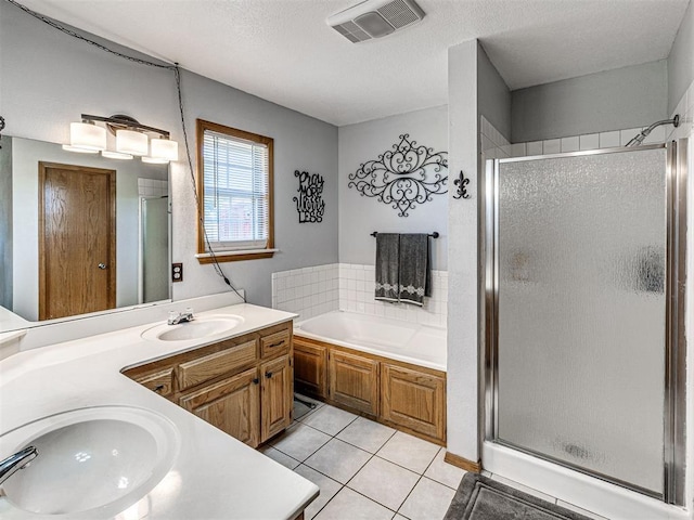 910860 S 3350th Rd, Wellston, OK 74881 - full bathroom featuring vanity, visible vents, tile patterned floors, a shower stall, and a garden tub