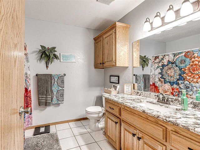 910860 S 3350th Rd, Wellston, OK 74881 - bathroom featuring toilet, baseboards, tile patterned floors, and vanity