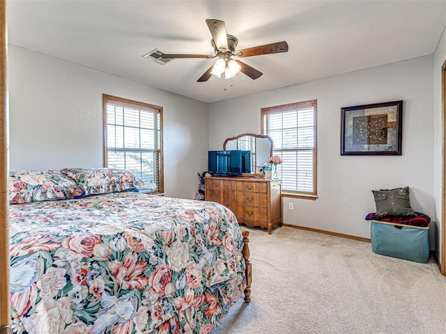 910860 S 3350th Rd, Wellston, OK 74881 - carpeted bedroom featuring baseboards, multiple windows, ceiling fan, and visible vents
