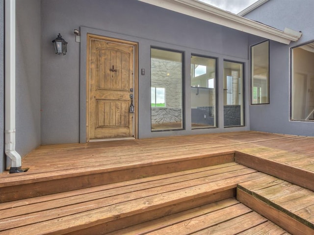 view of exterior entry featuring stucco siding