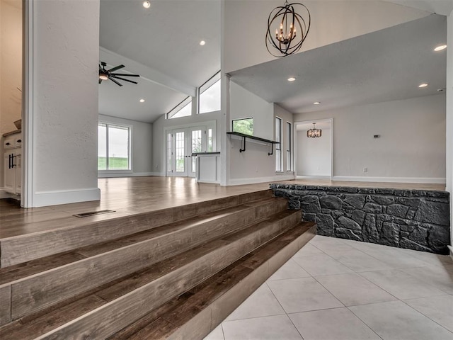 staircase with recessed lighting, high vaulted ceiling, tile patterned flooring, and ceiling fan with notable chandelier