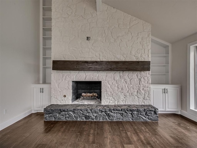 interior details with baseboards, built in features, wood finished floors, and a fireplace