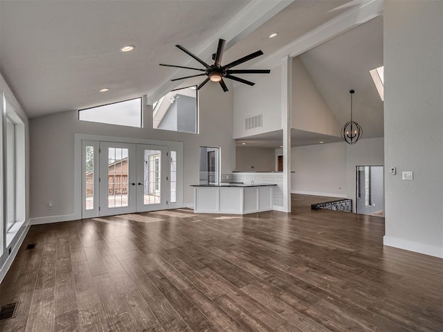 unfurnished living room with visible vents, baseboards, wood finished floors, and french doors