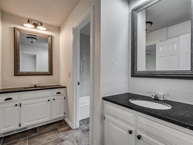 bathroom with two vanities and a sink