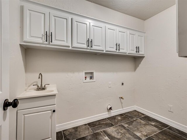 laundry area with cabinet space, a sink, hookup for a washing machine, gas dryer hookup, and baseboards