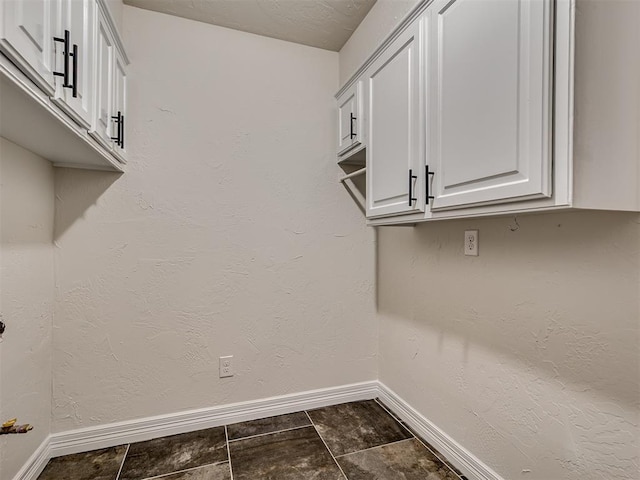 washroom featuring baseboards