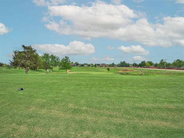 surrounding community with a lawn and golf course view