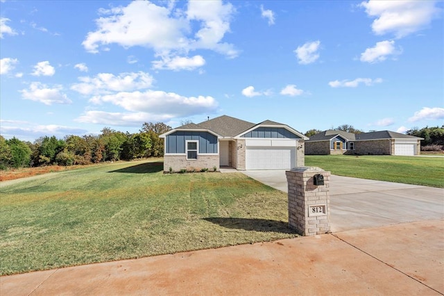 812 Stella Trl, Guthrie, OK 73044 - view of front of property with board and batten siding, a front yard, brick siding, concrete driveway, and an attached garage