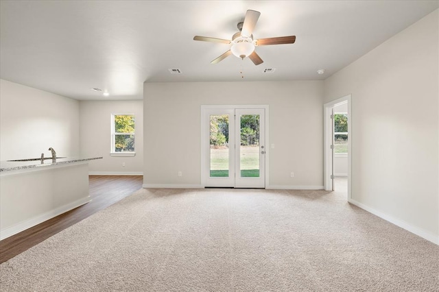 812 Stella Trl, Guthrie, OK 73044 - unfurnished living room with carpet floors, a ceiling fan, baseboards, and visible vents