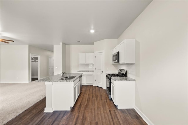 812 Stella Trl, Guthrie, OK 73044 - kitchen featuring baseboards, open floor plan, a sink, and appliances with stainless steel finishes