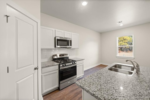 812 Stella Trl, Guthrie, OK 73044 - kitchen with visible vents, white cabinetry, light stone counters, a sink, and appliances with stainless steel finishes