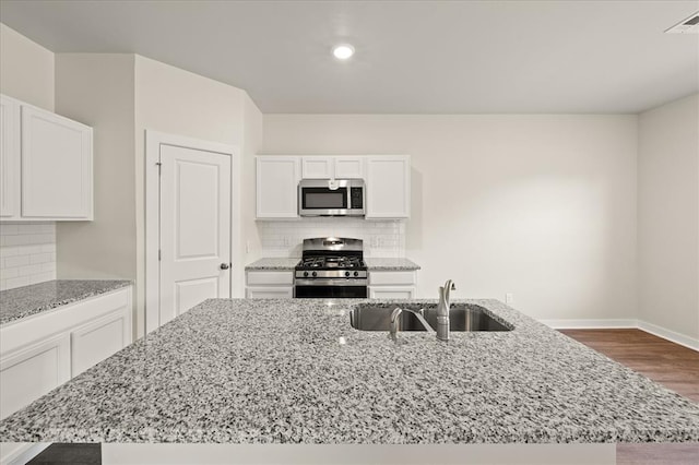 812 Stella Trl, Guthrie, OK 73044 - kitchen featuring white cabinets, stainless steel appliances, light stone counters, and a sink