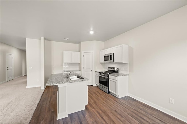 812 Stella Trl, Guthrie, OK 73044 - kitchen featuring light stone countertops, baseboards, a sink, appliances with stainless steel finishes, and backsplash