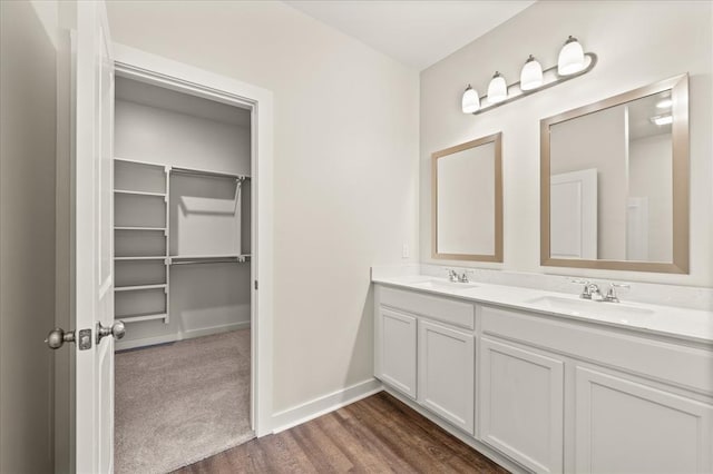 812 Stella Trl, Guthrie, OK 73044 - full bath with double vanity, baseboards, a sink, and wood finished floors