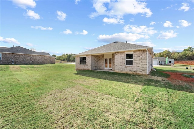 812 Stella Trl, Guthrie, OK 73044 - rear view of house featuring a yard, brick siding, and french doors