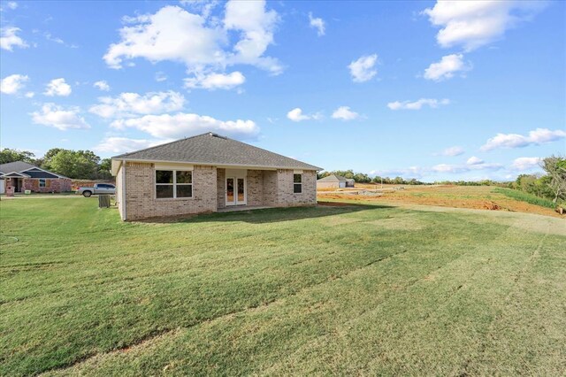 812 Stella Trl, Guthrie, OK 73044 - back of house with a lawn, a shingled roof, french doors, and brick siding