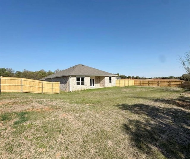 812 Stella Trl, Guthrie, OK 73044 - rear view of property featuring a fenced backyard and brick siding