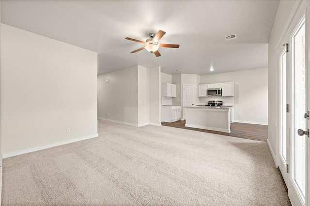 812 Stella Trl, Guthrie, OK 73044 - unfurnished living room featuring carpet floors and a ceiling fan