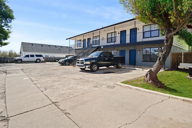 3509 N Nesbitt Ave, Oklahoma City, OK 73112 - view of building exterior featuring uncovered parking, stairway, and fence