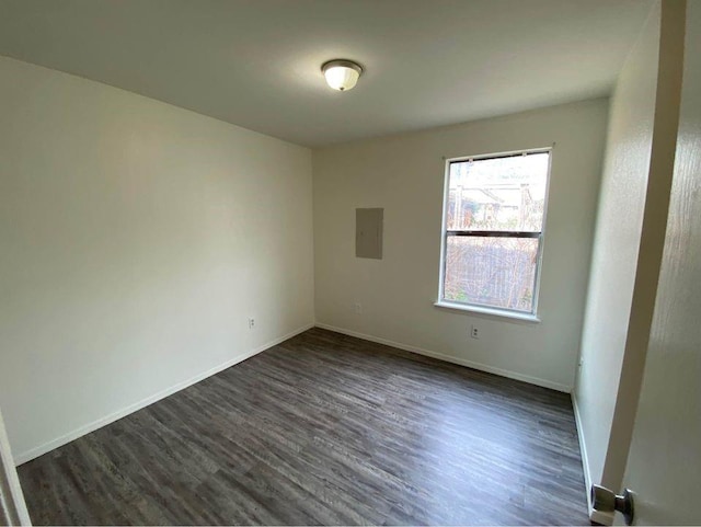 3509 N Nesbitt Ave, Oklahoma City, OK 73112 - spare room with dark wood-type flooring, electric panel, and baseboards