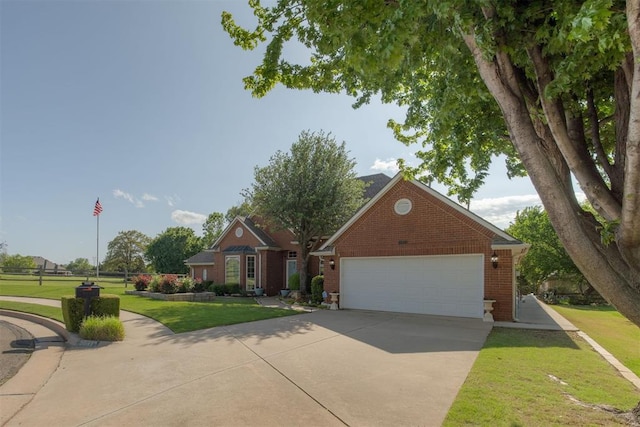 view of front of home with brick siding, a front yard, and concrete driveway