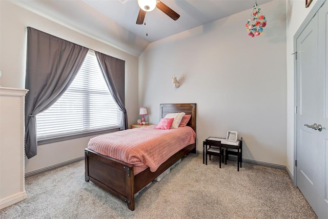 bedroom with light colored carpet, multiple windows, and a ceiling fan