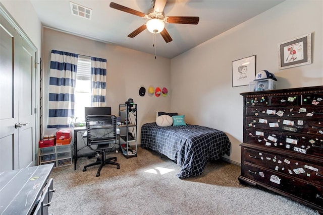 bedroom featuring carpet, an office area, and ceiling fan