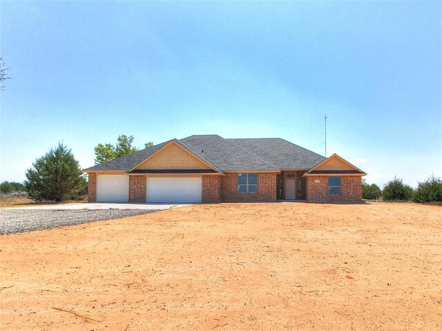 343787 E 870th Rd, Chandler, OK 74834 - ranch-style home featuring brick siding, an attached garage, and driveway